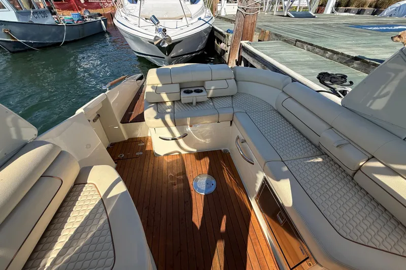 Slide: The Image of 2019 Chris-Craft Launch 28 GT boat interior with luxurious seating and wooden deck. - 7
