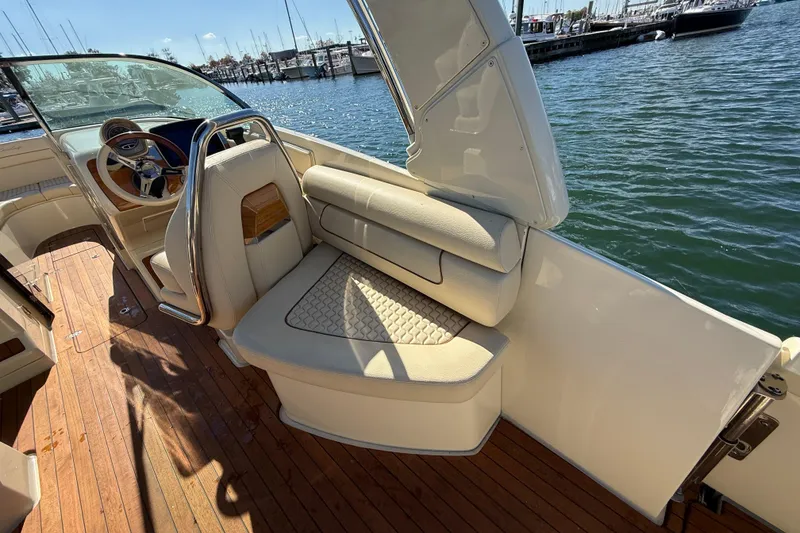 Slide: The Image of 2019 Chris-Craft Launch 28 GT boat interior with elegant seating and wooden deck. - 8
