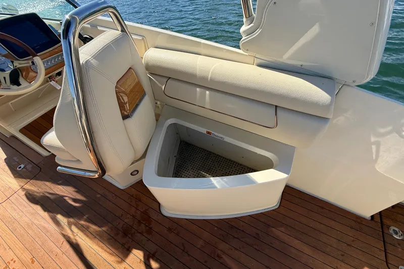 Slide: The Image of 2019 Chris-Craft Launch 28 GT interior with open storage compartment and elegant seating. - 9