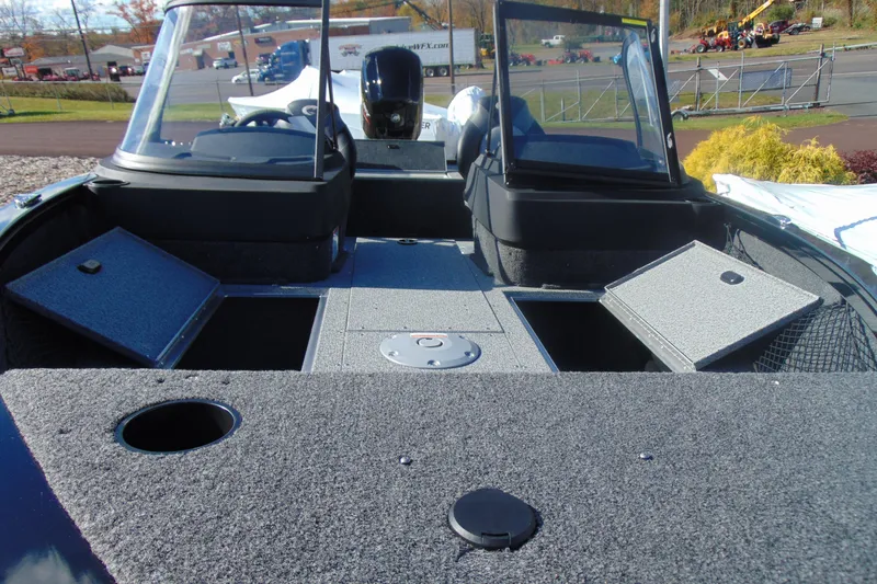 Slide: The Image of 2026 Crestliner 1750 Hawk boat interior with open storage compartments and windshield. - 11