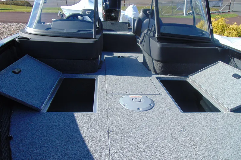 Slide: The Image of 2026 Crestliner 1750 Hawk boat interior with open storage compartments and dual consoles. - 12