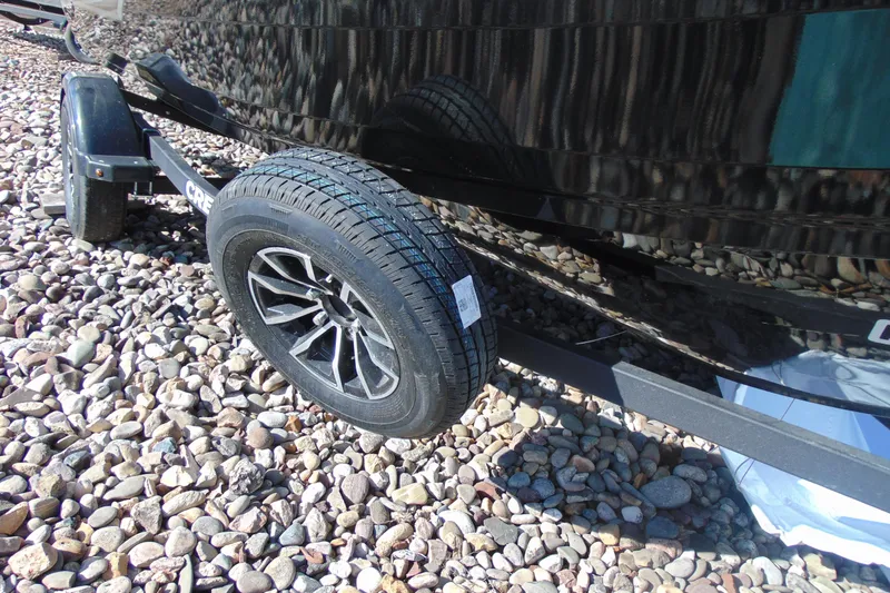 Slide: The Image of 2026 Crestliner 1750 Hawk trailer tire on rocky ground. - 13