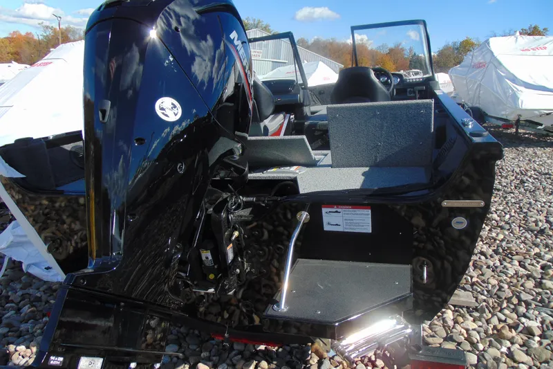 Slide: The Image of 2026 Crestliner 1750 Hawk boat with Mercury outboard engine, displayed outdoors on gravel. - 4