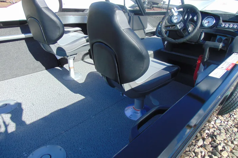 Slide: The Image of 2026 Crestliner 1750 Hawk boat interior with steering wheel and seating. - 7