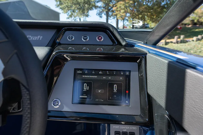 Slide: The Image of 2026 MasterCraft NXT23 dashboard with digital display and control buttons. - 11