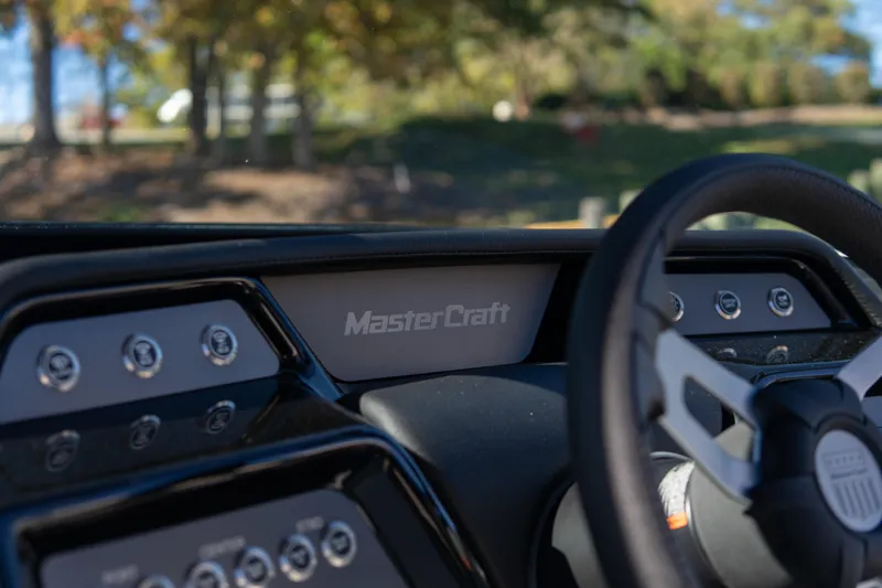 Slide: The Image of Dashboard of 2026 MasterCraft NXT23 boat with steering wheel and controls. - 12