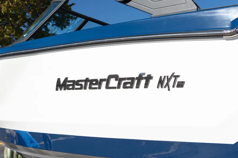 Slide: The Image of 2026 MasterCraft NXT23 boat with sleek blue and white design. - 13
