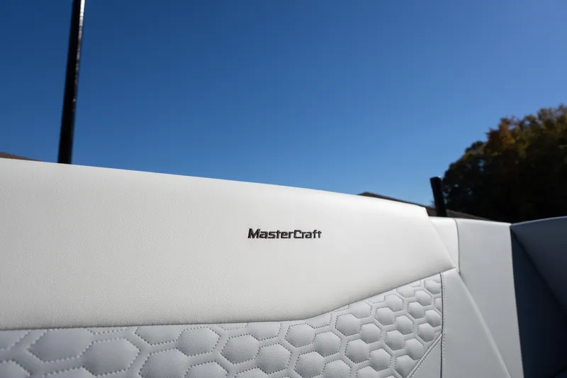Slide: The Image of 2026 MasterCraft NXT23 boat interior with white upholstery and hexagonal pattern. - 15