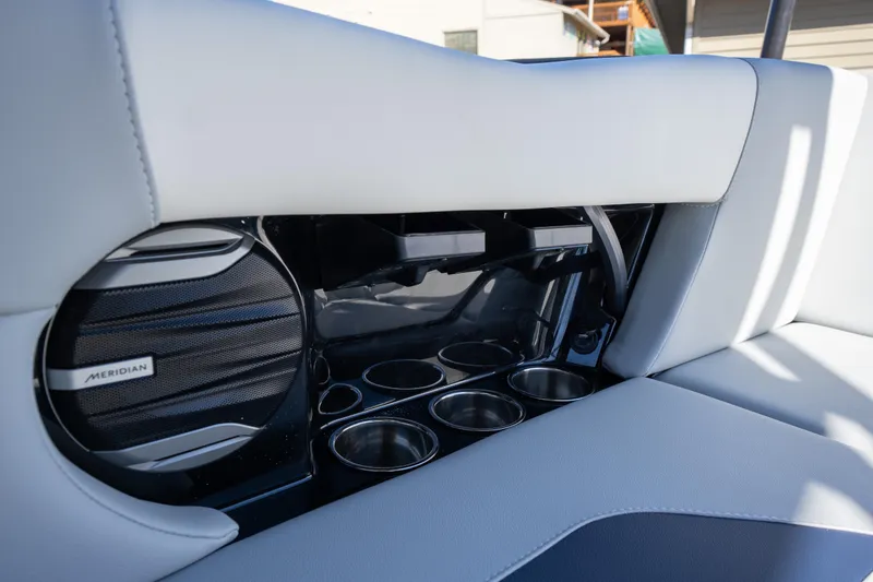 Slide: The Image of 2026 MasterCraft NXT23 interior with Meridian speaker and cup holders. - 16