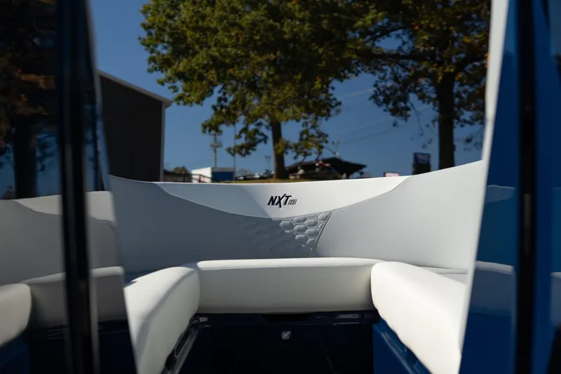 Slide: The Image of Interior view of 2026 MasterCraft NXT23 boat with white seating and logo. - 18