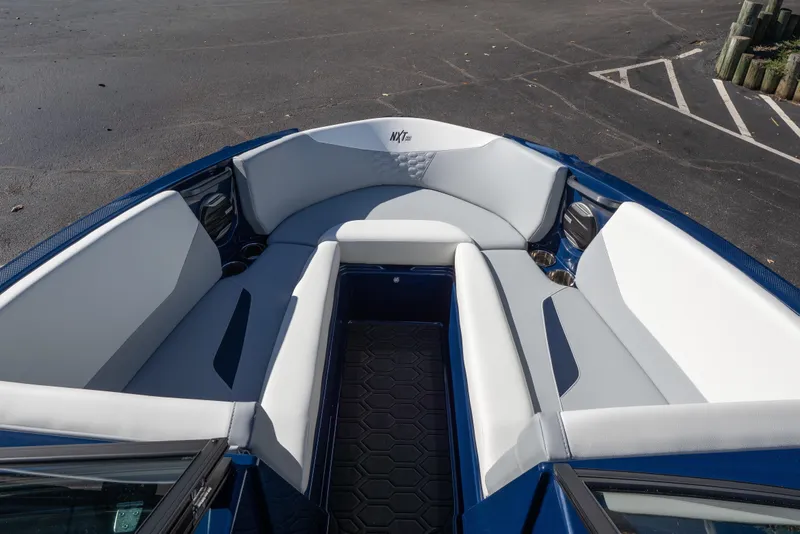 Slide: The Image of 2026 MasterCraft NXT23 boat interior with white seating and blue accents. - 5