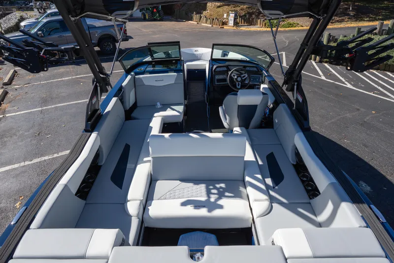 Slide: The Image of 2026 MasterCraft NXT23 boat interior with spacious seating and modern dashboard design. - 6