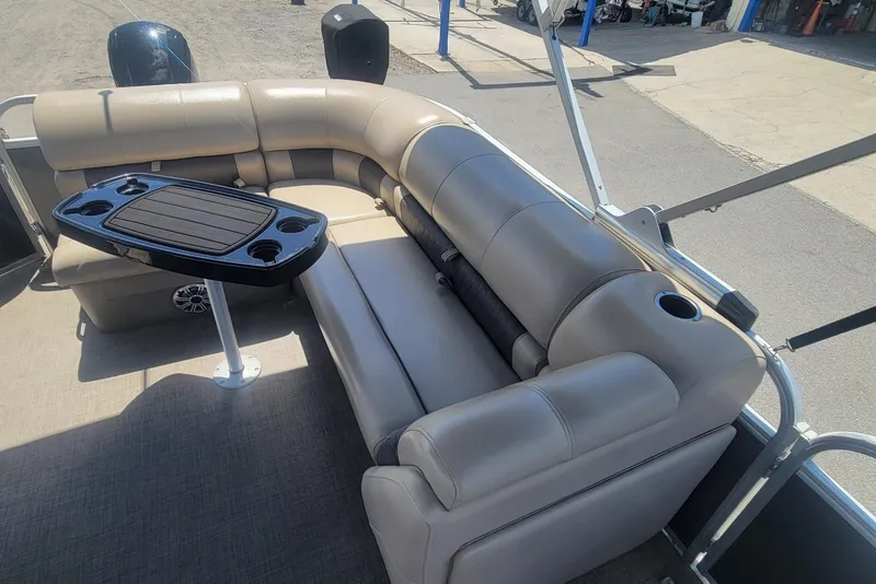 Slide: The Image of 2023 Sun Tracker Party Barge 20 DLX with comfortable seating and table setup. - 10