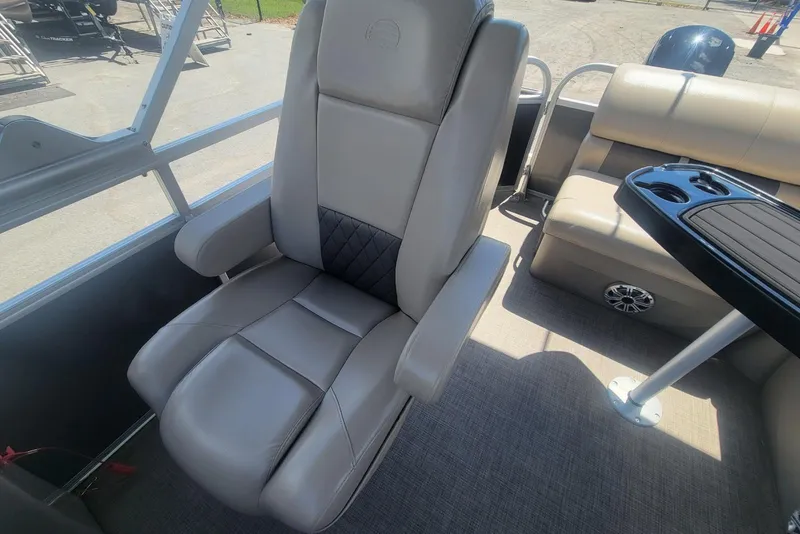 Slide: The Image of 2023 Sun Tracker Party Barge 20 DLX interior with comfortable seating and table. - 12