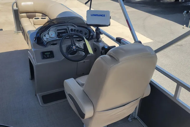 Slide: The Image of 2023 Sun Tracker Party Barge 20 DLX interior with steering console and seating. - 18