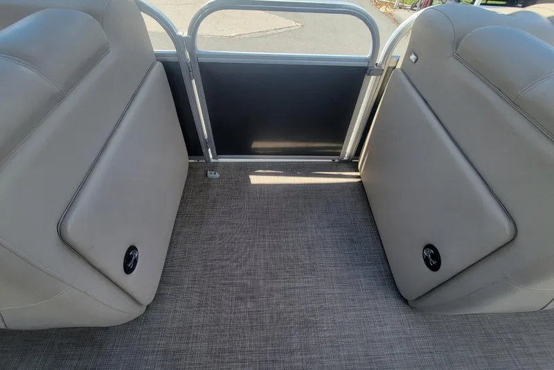 Slide: The Image of 2023 Sun Tracker Party Barge 20 DLX interior seating with gray upholstery and flooring. - 20