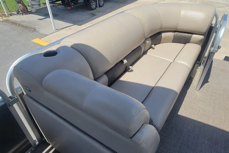 Slide: The Image of 2023 Sun Tracker Party Barge 20 DLX with beige seating and cup holder. - 21