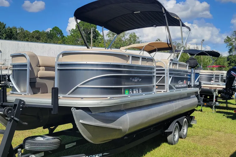 Slide: The Image of 2023 Sun Tracker Party Barge 20 DLX pontoon boat on trailer, outdoor display. - 3