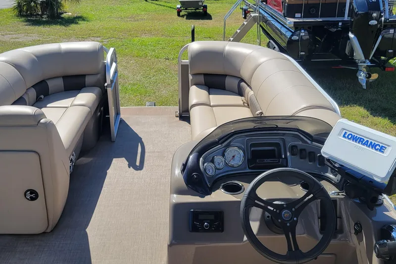 Slide: The Image of 2023 Sun Tracker Party Barge 20 DLX interior with plush seating and modern dashboard. - 5
