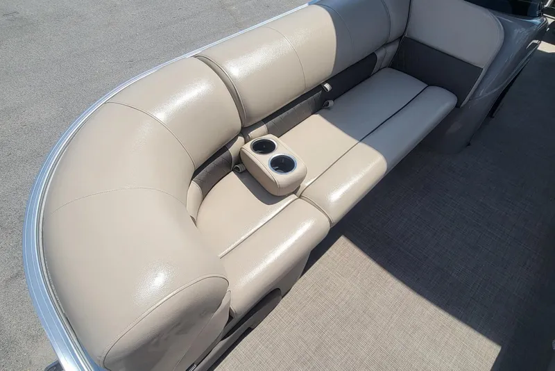 Slide: The Image of 2023 Sun Tracker Party Barge 20 DLX seating with cup holders, beige upholstery. - 9