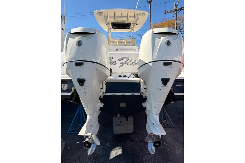 Slide: The Image of 2006 Mako 284 Center Console boat with dual outboard engines, rear view. - 3