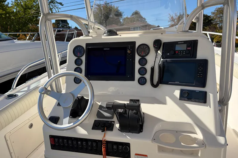 Slide: The Image of 2006 Mako 284 Center Console boat dashboard with steering wheel and navigation equipment. - 5