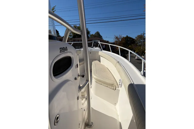 Slide: The Image of 2006 Mako 284 Center Console boat interior with seating and railing. - 8