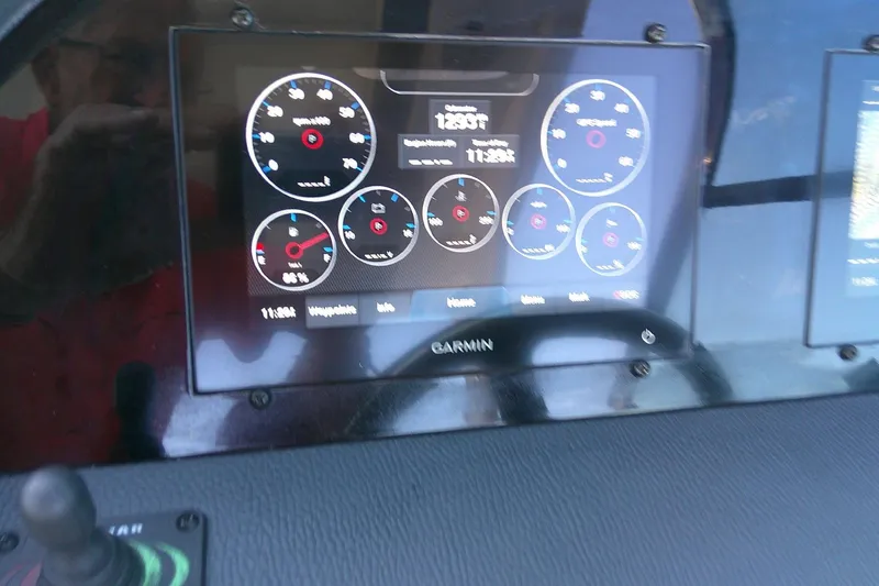 Slide: The Image of Garmin display on 2022 Regal 29 OBX boat dashboard showing various gauges and controls. - 15
