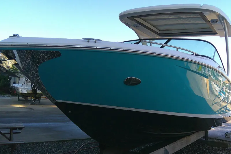 Slide: The Image of 2022 Regal 29 OBX boat with sleek turquoise hull and modern design. - 2