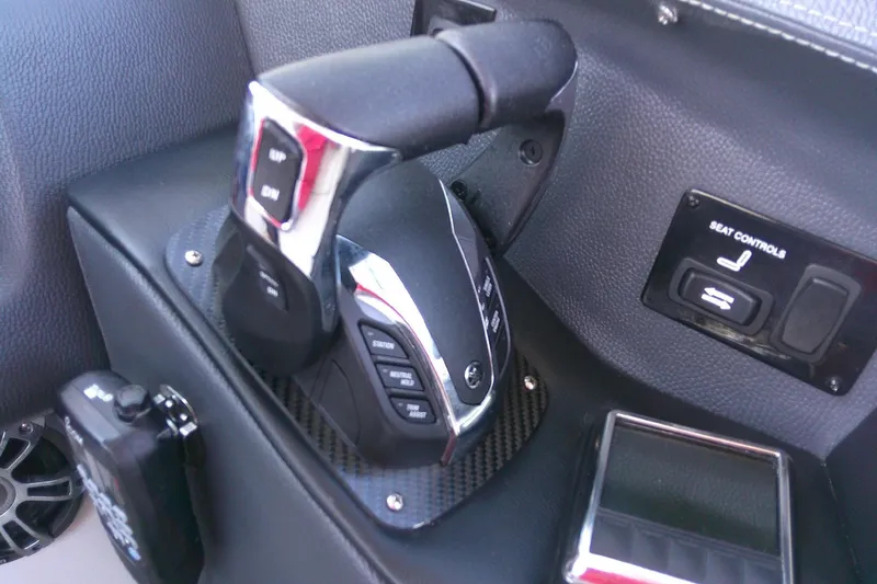 Slide: The Image of Control panel of 2022 Regal 29 OBX boat with throttle and seat controls. - 24