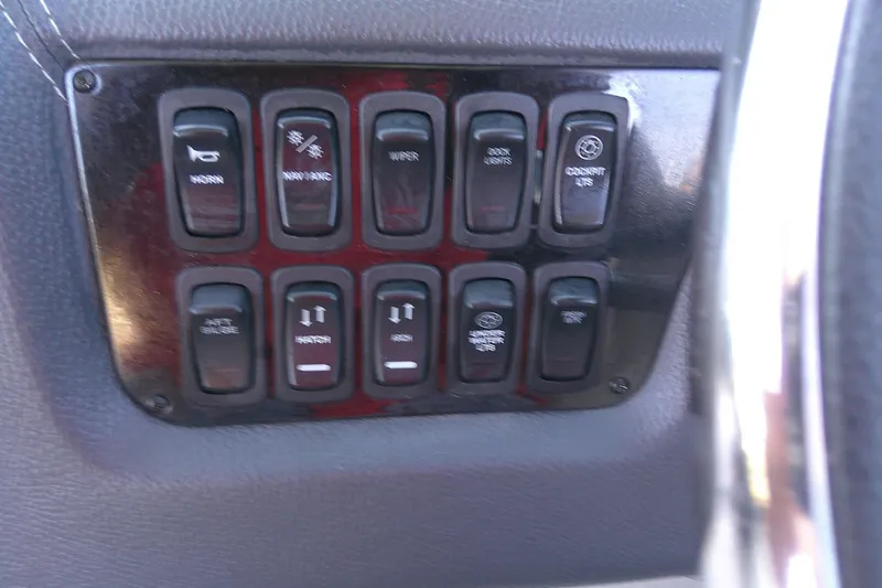 Slide: The Image of Control panel of a 2022 Regal 29 OBX boat with various switches. - 28