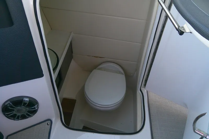 Slide: The Image of 2022 Regal 29 OBX boat interior with compact marine toilet. - 30