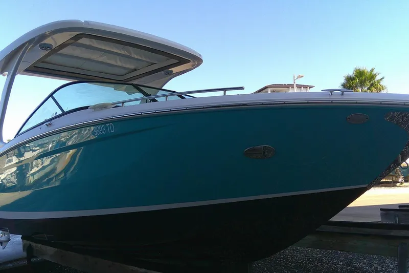 Slide: The Image of 2022 Regal 29 OBX boat with sleek design, docked under clear blue sky. - 4