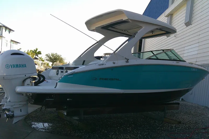 Slide: The Image of 2022 Regal 29 OBX boat with Yamaha outboard engine, docked outdoors. - 5