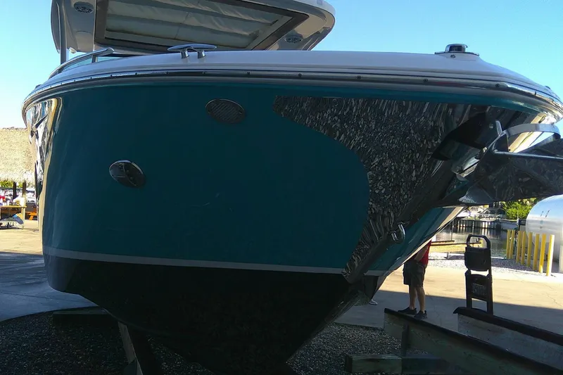 Slide: The Image of 2022 Regal 29 OBX boat on display, showcasing sleek design and vibrant blue hull. - 6