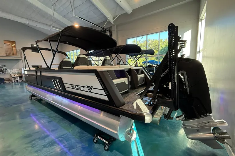 Slide: The Image of 2026 Viaggio Diamante Q pontoon boat in showroom with modern design and sleek features. - 2