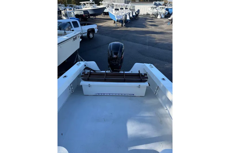 Slide: The Image of 2016 Eastern Seaway boat with outboard motor in a marina setting. - 3