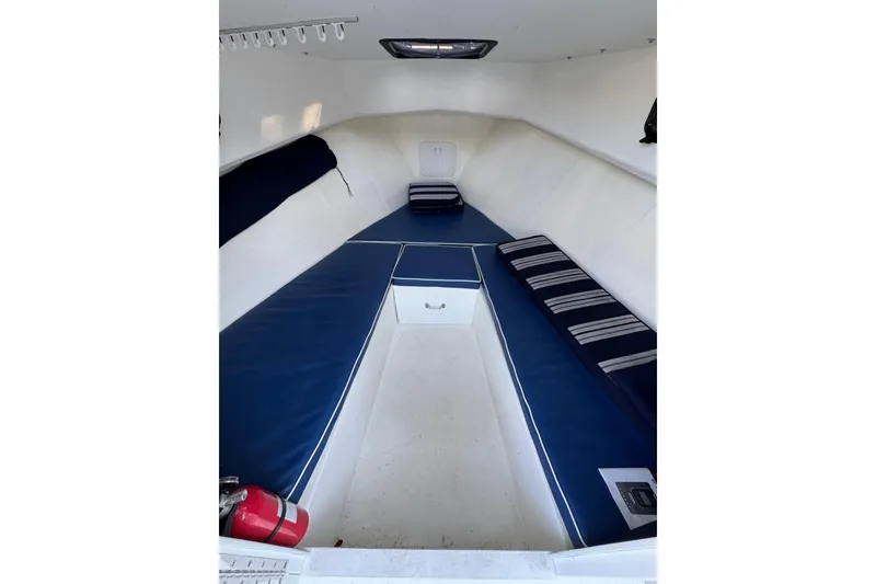 Slide: The Image of 2016 Eastern Seaway boat interior with blue cushions and white walls. - 6