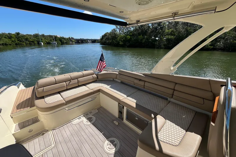 Slide: The Image of 2022 Chris-Craft Launch 35 GT I/O boat interior with luxurious seating and scenic water view. - 12