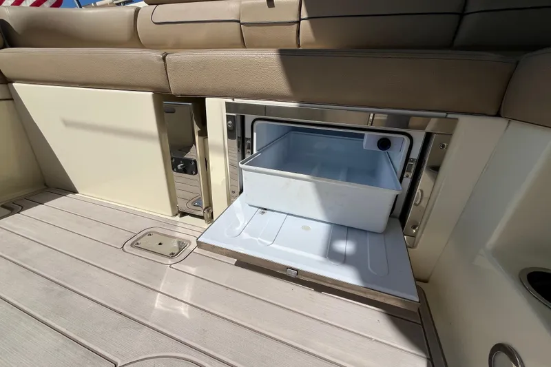 Slide: The Image of 2022 Chris-Craft Launch 35 GT I/O boat interior with open storage compartment. - 16