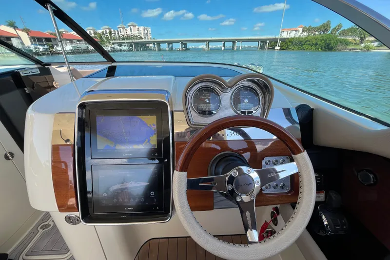 Slide: The Image of 2022 Chris-Craft Launch 35 GT I/O dashboard with navigation screens and steering wheel. - 20