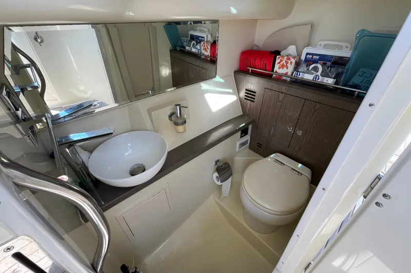 Slide: The Image of 2022 Chris-Craft Launch 35 GT I/O bathroom with modern sink, toilet, and storage cabinets. - 26