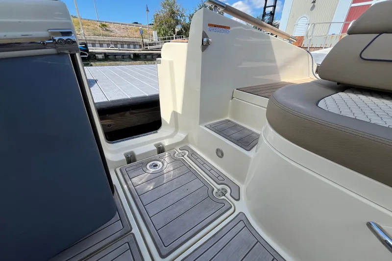 Slide: The Image of 2022 Chris-Craft Launch 35 GT I/O boat interior with teak flooring and cushioned seating. - 28