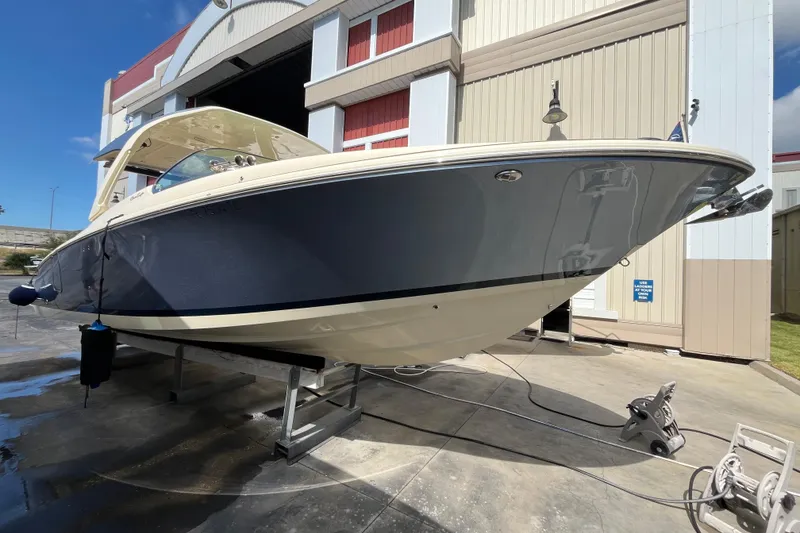 Slide: The Image of 2022 Chris-Craft Launch 35 GT I/O boat displayed in a marina setting. - 7