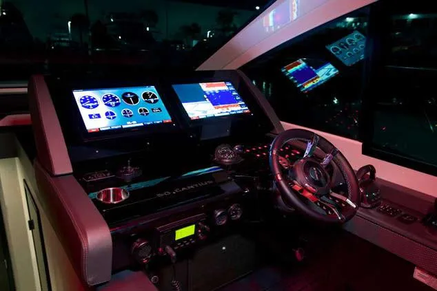 Slide: The Image of Helm of 2024 Cruisers Yachts 50 Cantius with advanced navigation displays and controls. - 24