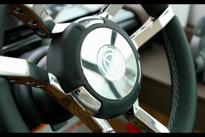 Slide: The Image of Steering wheel of 2024 Cruisers Yachts 50 Cantius, featuring sleek chrome and leather design. - 26