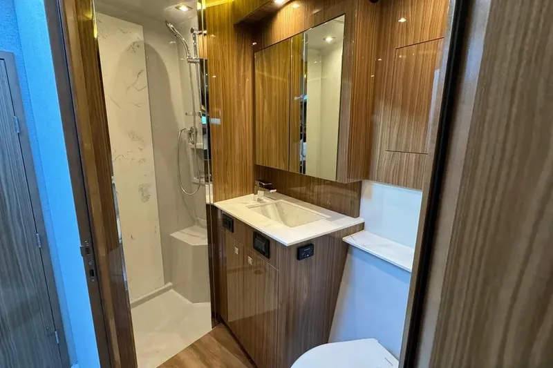 Slide: The Image of Luxurious bathroom in 2024 Cruisers Yachts 50 Cantius with wood accents and modern fixtures. - 37