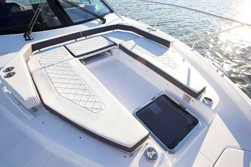 Slide: The Image of 2024 Cruisers Yachts 50 Cantius deck with cushioned seating and ocean view. - 50