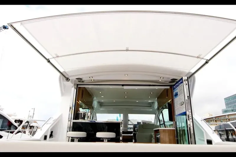 Slide: The Image of 2024 Cruisers Yachts 50 Cantius luxury yacht interior with open deck view. - 7