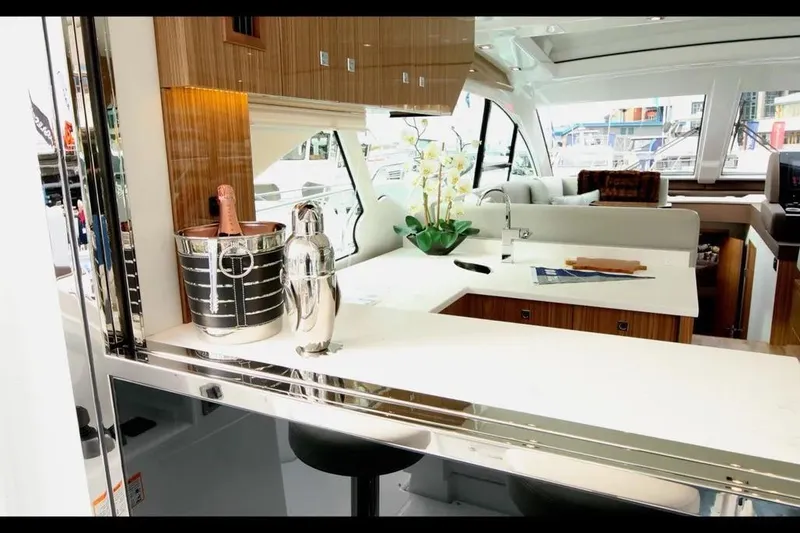 Slide: The Image of Luxurious interior of 2024 Cruisers Yachts 50 Cantius with modern kitchen and elegant decor. - 12